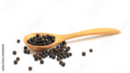 Peppercorn with wooden spoon on white background. Composition isolated over the white background.