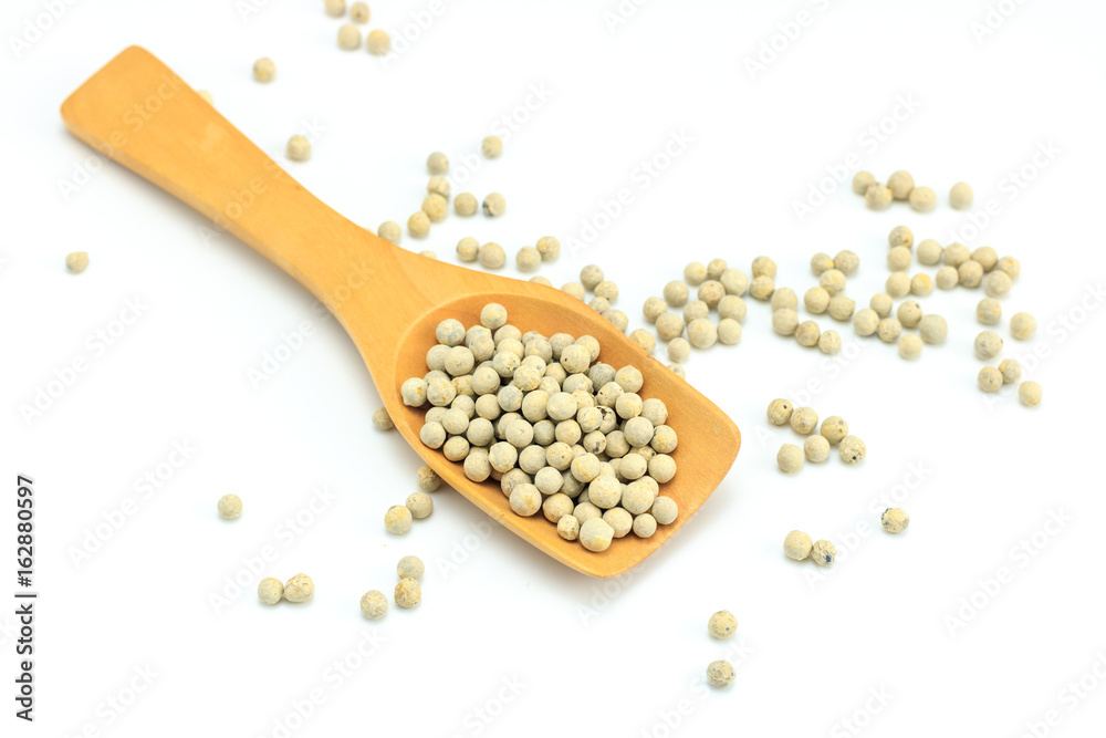 Peppercorn with wooden spoon on white background. Composition isolated over the white background. Peppercorn with wooden spoon on white background. Composition isolated over the white background.