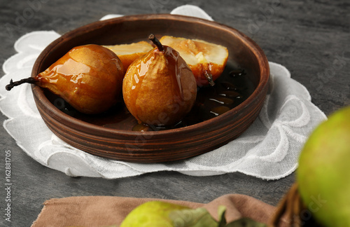 Baked pears served on wooden plate
