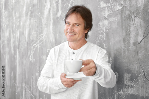 Mature man holding cup of t...
