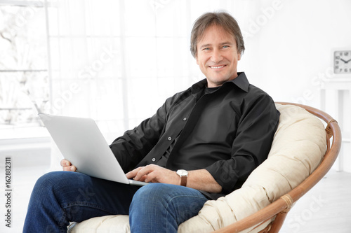 Mature man sitting on chair...