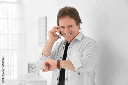 Mature man talking on phone...