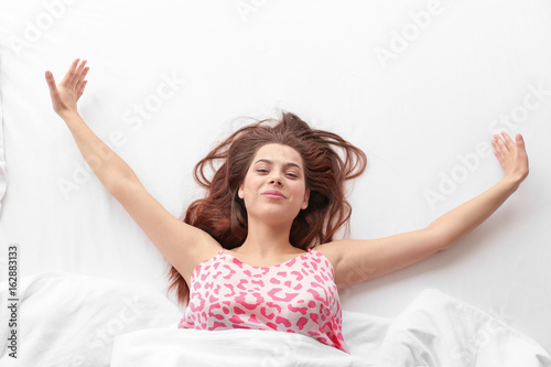 Young woman relaxing in bed