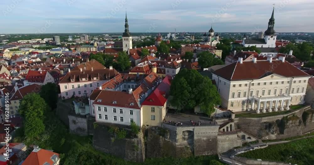 Building of government of Estonia and Church of St. Nicholas on background. The Old Town of Tallinn. Aerial view. Estonia, Europe