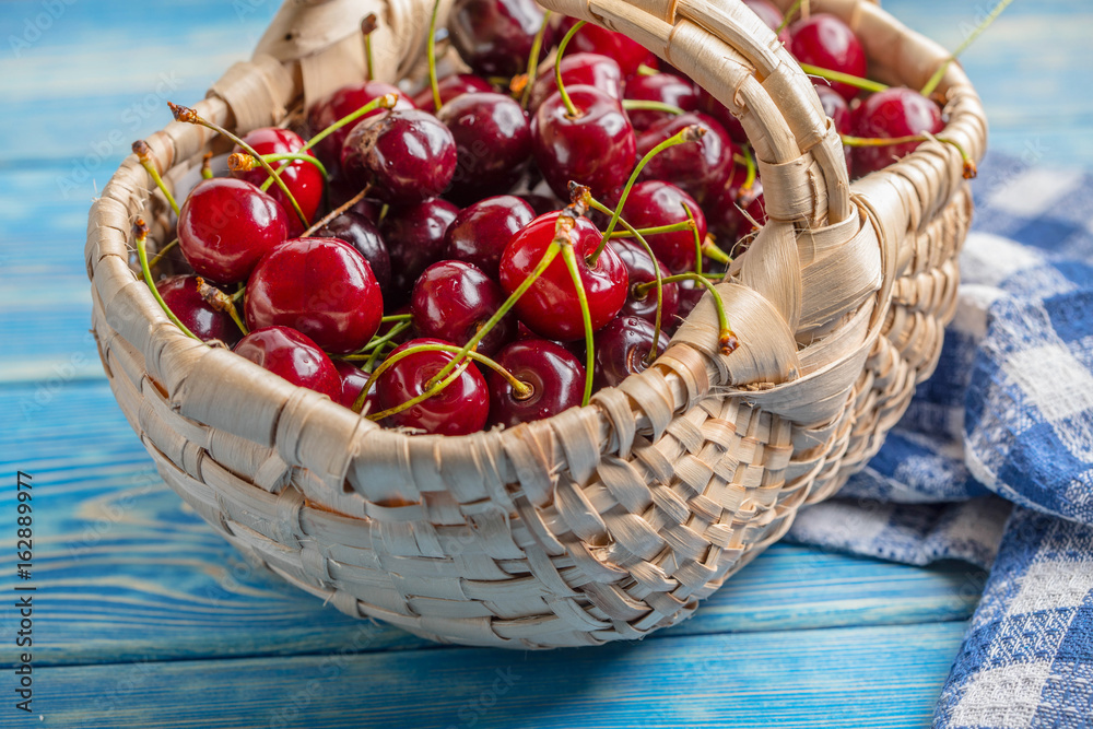 Fresh cherries in a wicker basket.