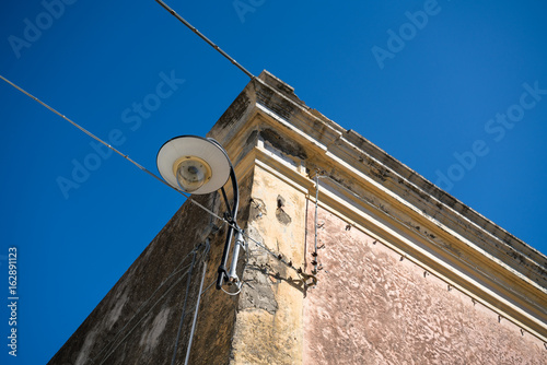 Witherd upper corner of a house with cables and nice lamp photo