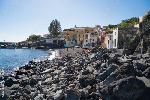 Small village Rinella with beach and many rocks photo