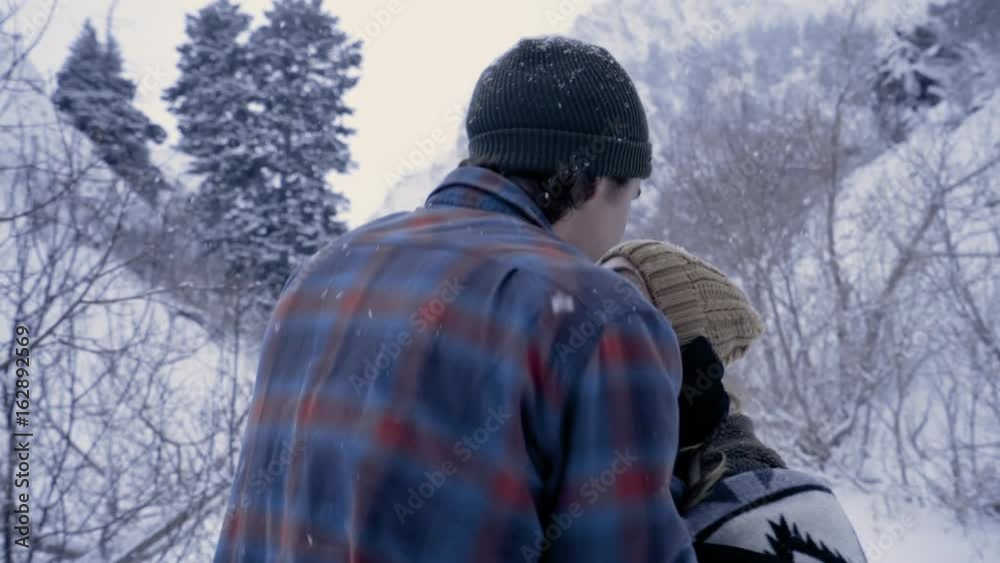 Romantic Couple Enjoy The Snowy Utah Mountains Together, Man Gives His Girlfriend A Kiss On Her Forehead