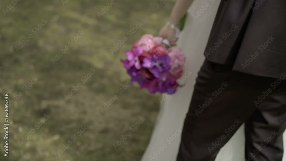 Young wedding couple embracing in a park Young wedding couple embracing in a park
