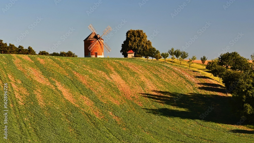 Beautiful old windmill and landscape with the sun. Chvalkovice - Czech Republic. Europe.