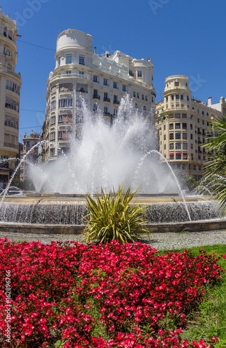 Fountain and flowers at the Plaza Ayuntamiento in Valencia