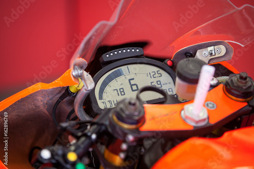 The dashboard with the speedometer on the instrument panel of the motorcycle closeup