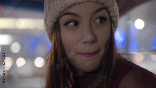 Closeup Of Young Woman Looking Over Her Shoulder At Backseat Passenger, She Sings To Them And Dances