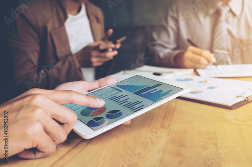 Co working conference, Business team meeting present, investor colleagues discussing new plan financial graph data on office table with laptop and digital tablet, Finance, accounting, investment
