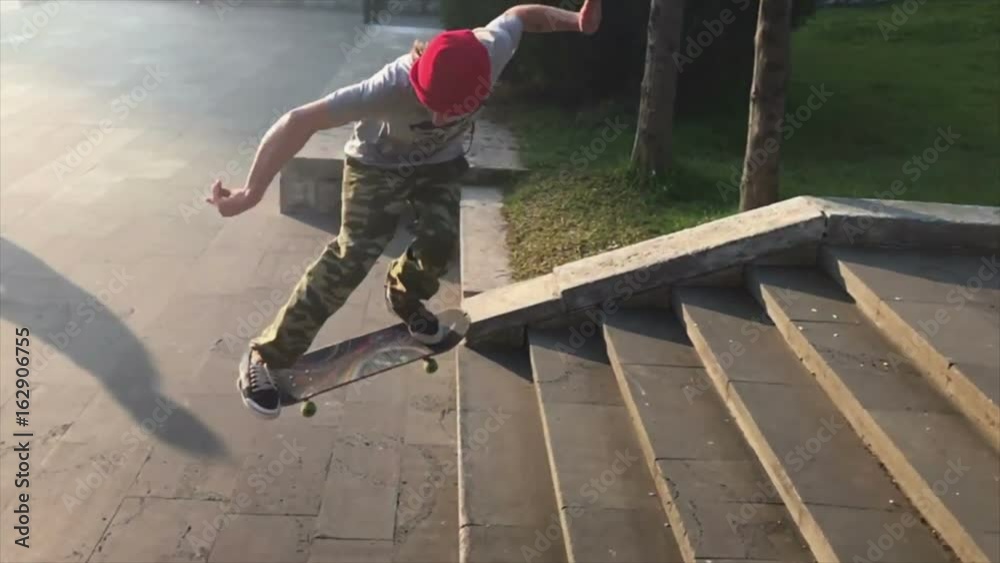 Skateboarder does trick from the steps. Slow motion