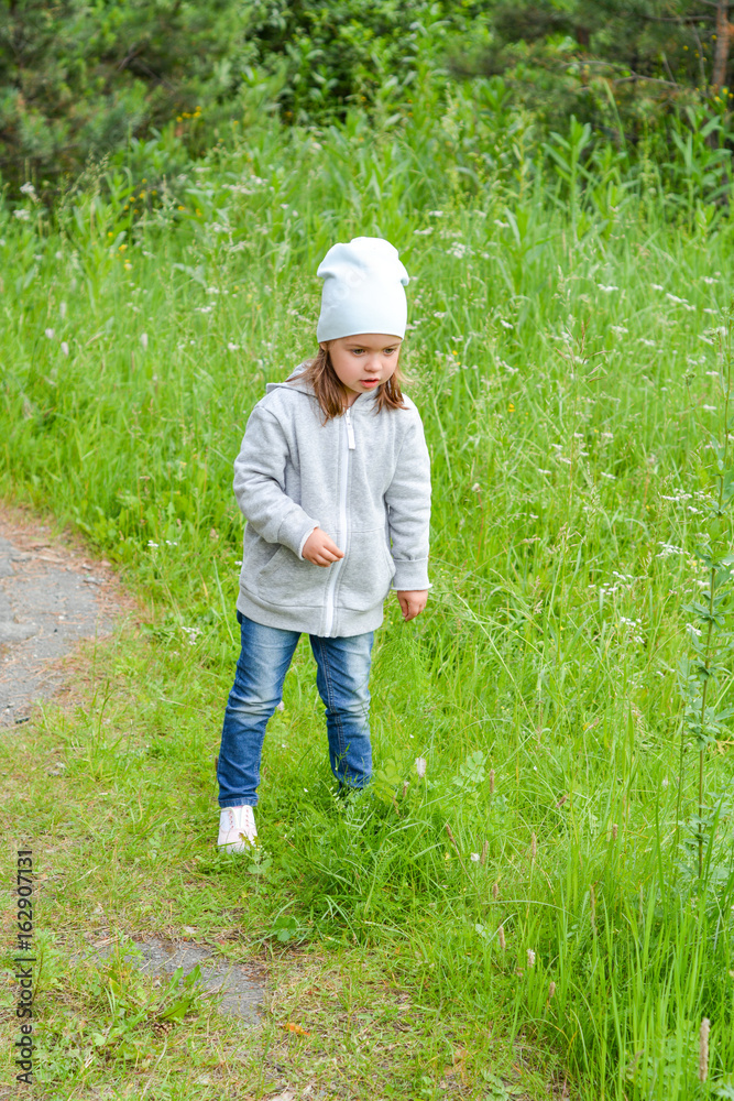 Little girl is walking in the summer forest Little girl is walking in the summer forest