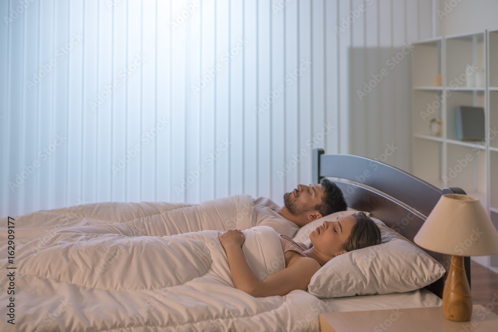 The man and woman sleeping in the bedroom The man and woman sleeping in the bedroom