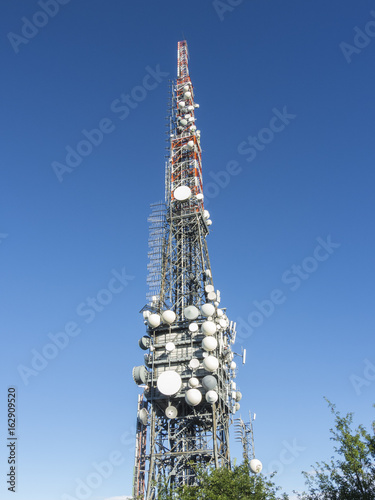 Group of towers for telecommunications on the top of the mountain. Electromagnetic and environmental pollution. Linzone mountain pick. Orobie Prealps. Italy