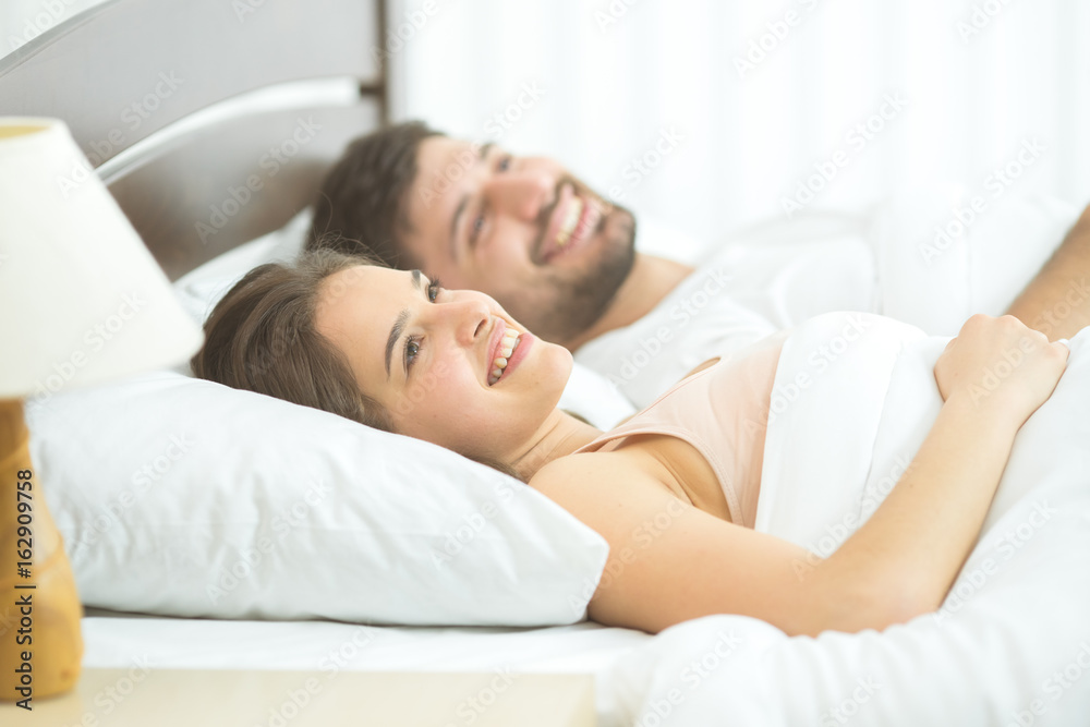 The happy couple sleeping in the comfortable bed The happy couple sleeping in the comfortable bed