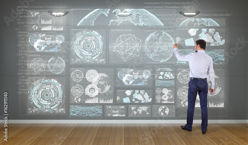 Businessman using graph screens interface on a wall 3D rendering