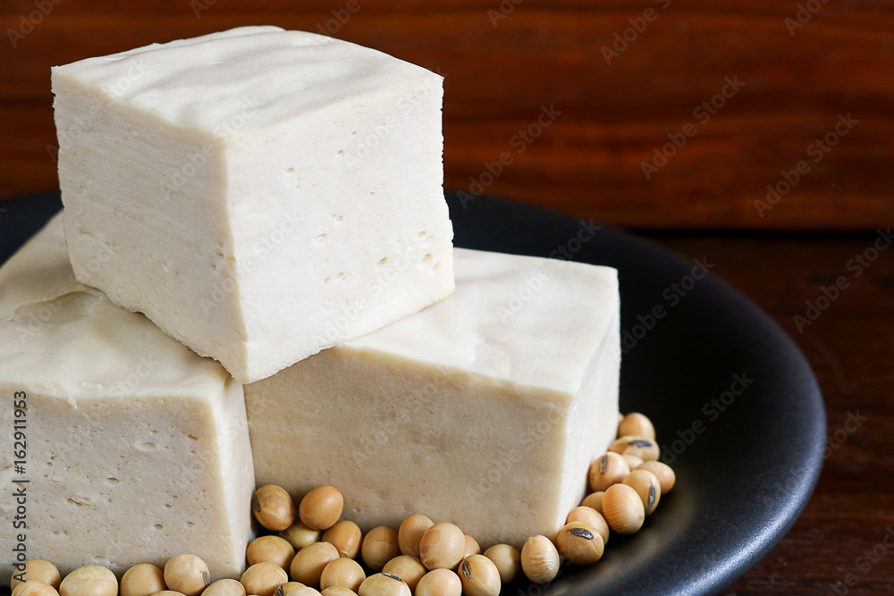 soy tofu or bean curd, Vegetarian food on wooden background.