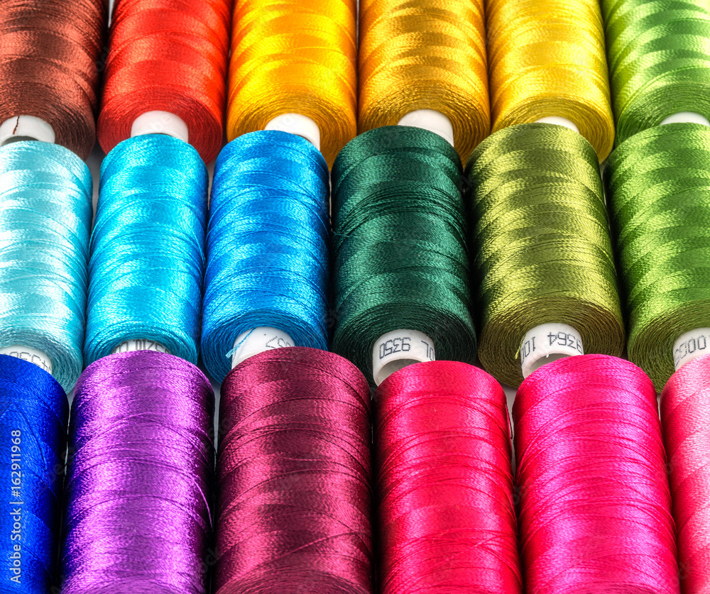 A bunch of spools of thread and spools of thread on a Image