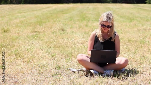 Wallpaper Mural Young woman writing on computer in park.  Torontodigital.ca