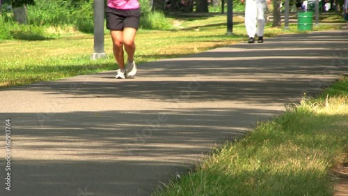 A walking path along Charles river in Boston provides perfect place to enjoy nature and outdoors on summer day.   photo