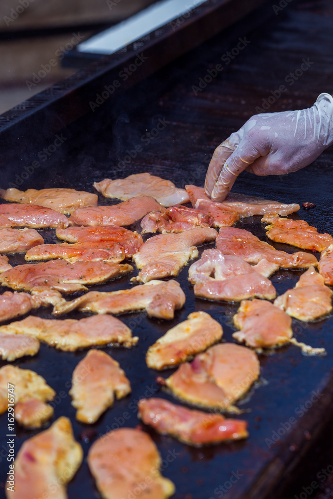 The chef prepares chicken fillet for frying. The process of preparing dinner. The chef prepares chicken fillet for frying. The process of preparing dinner.