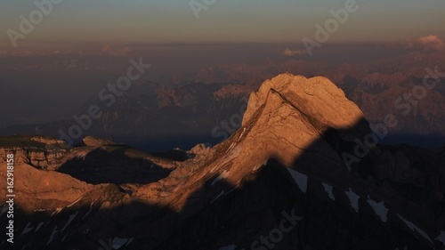 Bright lit peak of Mount Altmann, Appenzell Canton. Sunset view from Mount Santis, Switzerland.