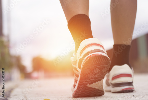 sport man with shoe are walking on road and exercise in morning, concept as health, winner and success