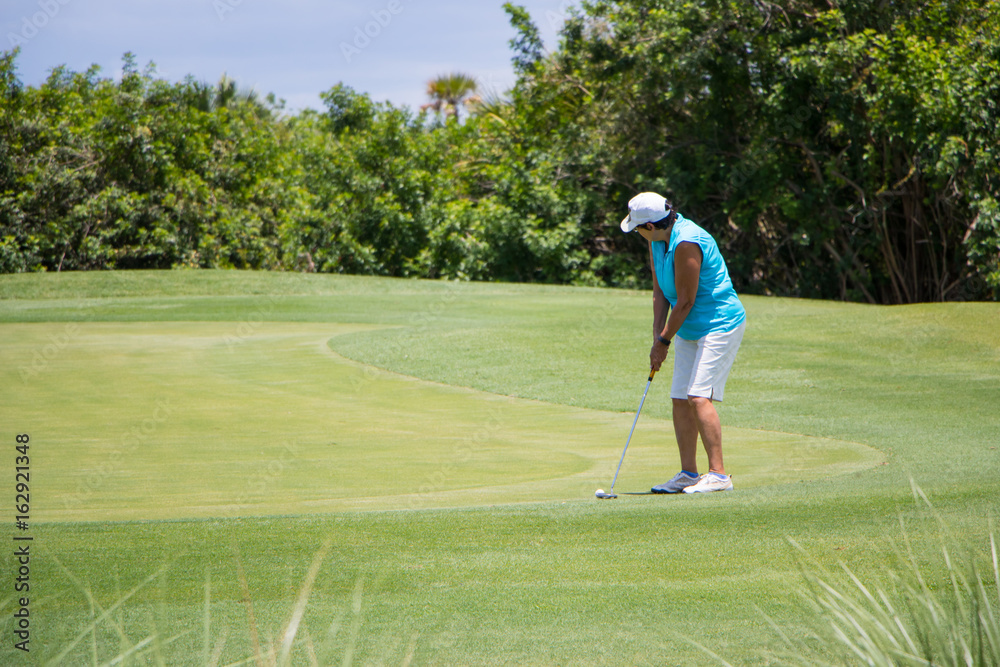 Golfer Putting Ball on Green
