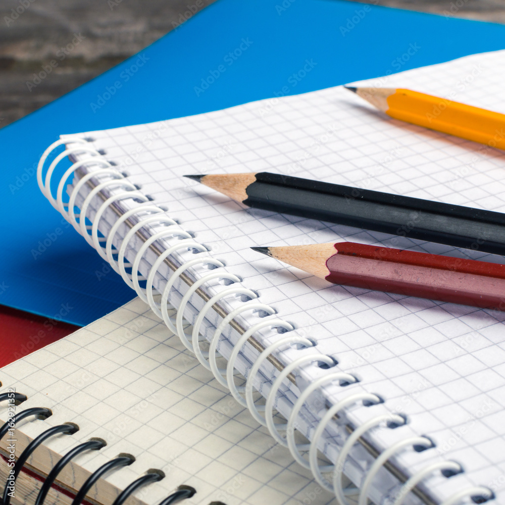 Back to School, supplies, notebook on the grey background. square Back to School, supplies, notebook on the grey background. square