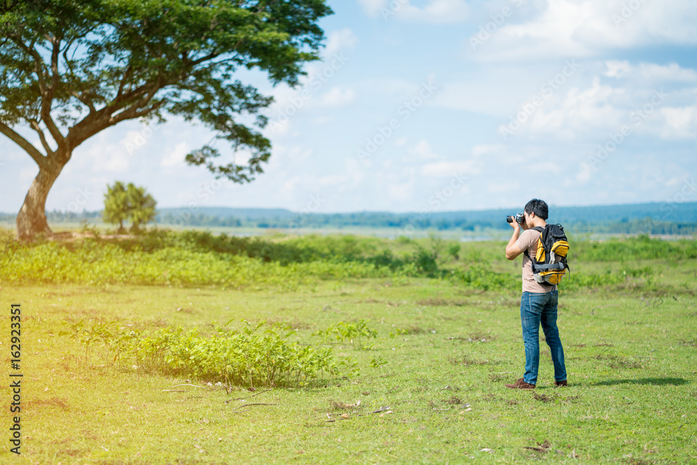 young tourist man photograph lanscape