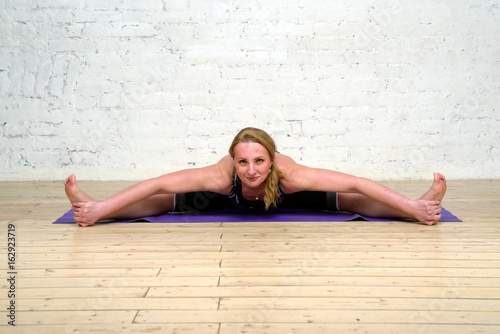 Adult woman practicing yoga photo