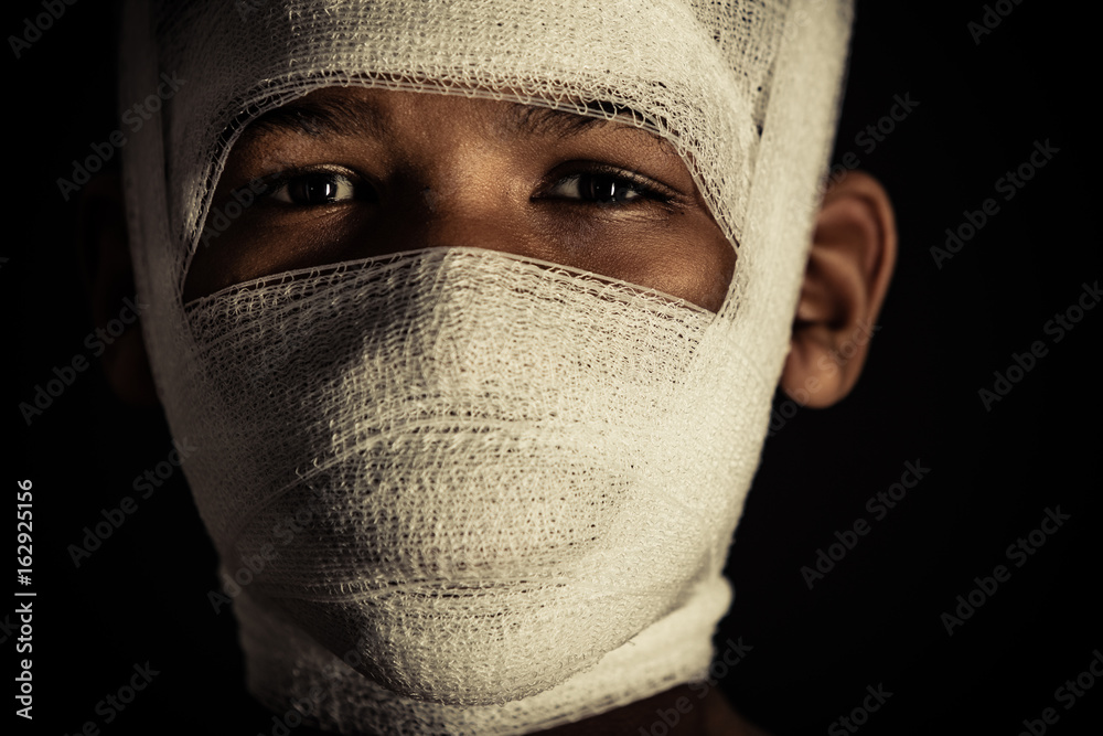Young black boy with bandages on his face Stock Photo | Adobe Stock