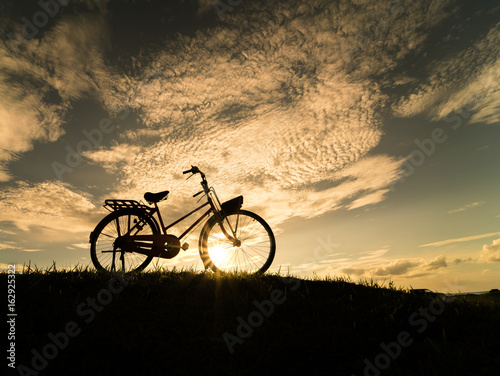 bicycle silhouette at the sunset or sunrise