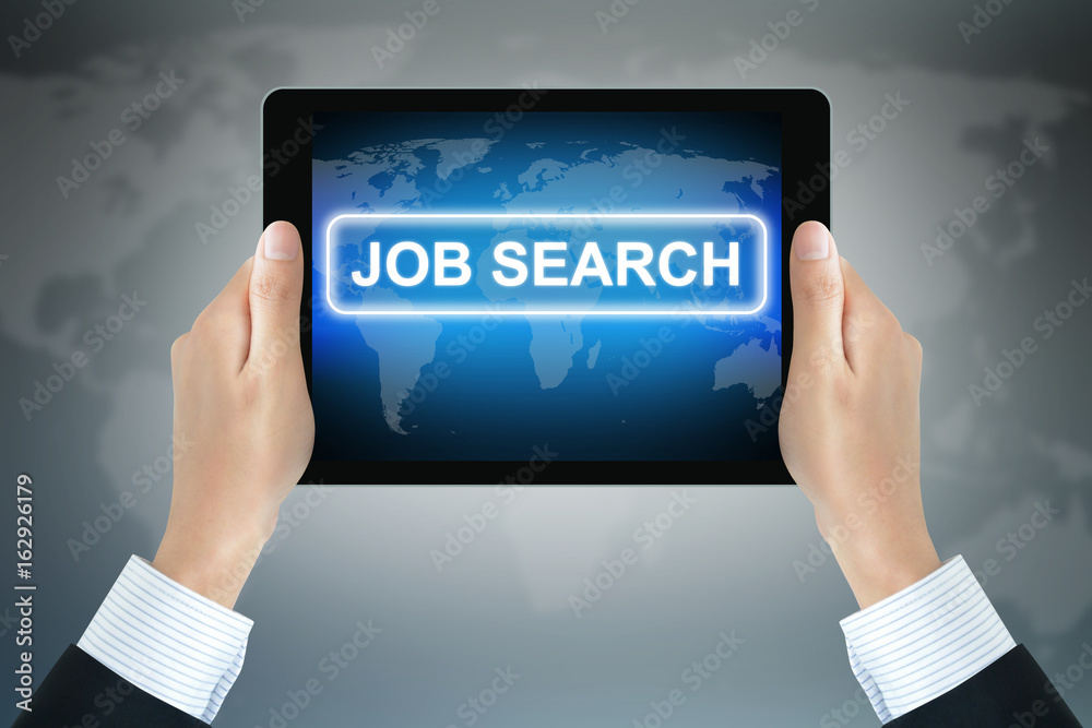 JOB SEARCH sign on tablet pc screen held by businessman hands JOB SEARCH sign on tablet pc screen held by businessman hands