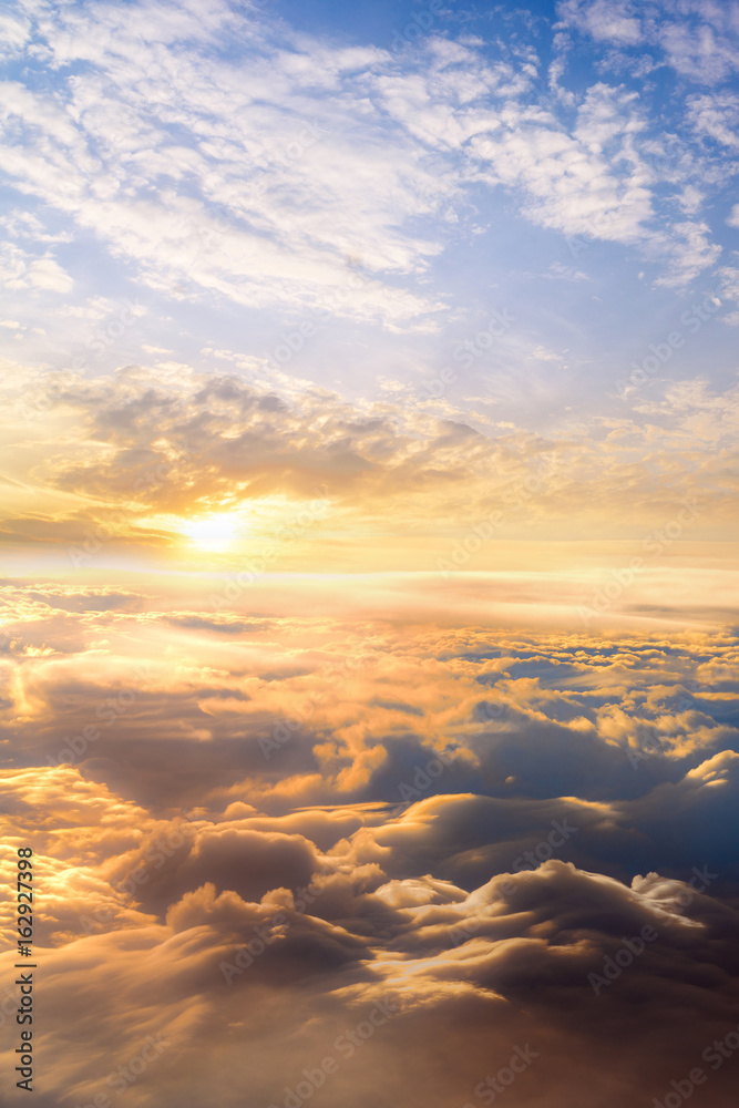 sunset clouds sky skyscape. view from the window of an airplane flying in the clouds, top view clouds like the sea of clouds sky background sunset clouds sky skyscape. view from the window of an airplane flying in the clouds, top view clouds like the sea of clouds sky background
