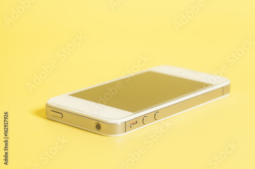 Smart phone white on a yellow background