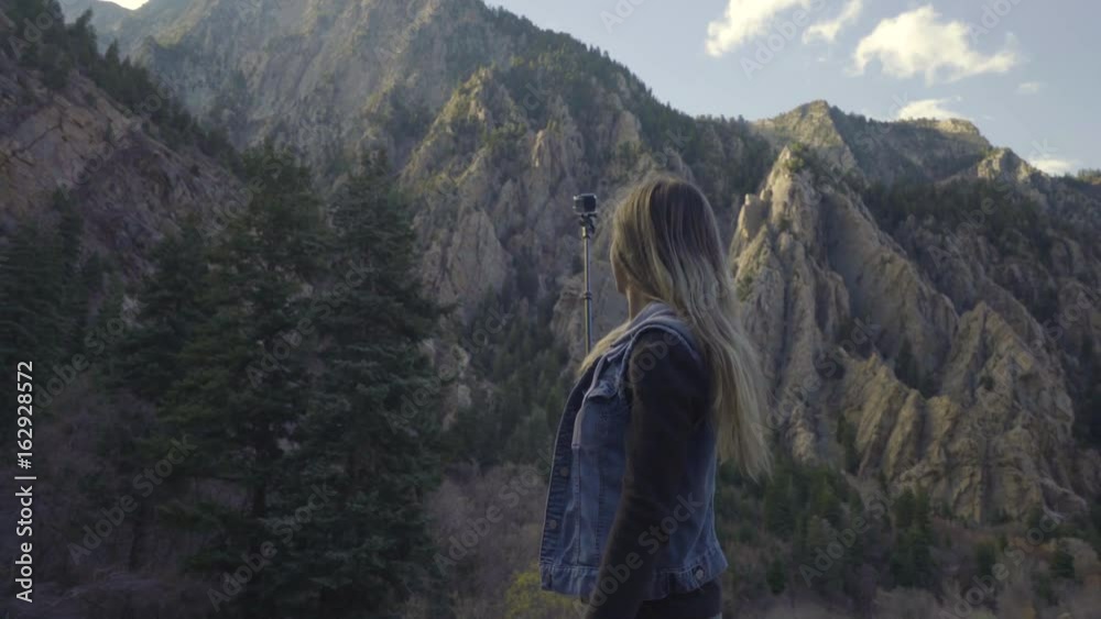 Portrait Of Happy Young Woman Taking A GoPro Adventure Video Of Herself In Utah Mountains Portrait Of Happy Young Woman Taking A GoPro Adventure Video Of Herself In Utah Mountains