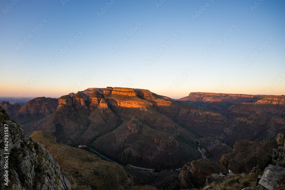 Naklejka premium Blyde River Canyon, famous travel destination in South Africa. Last sunlight on the mountain ridges. Ultra wide angle view from above.