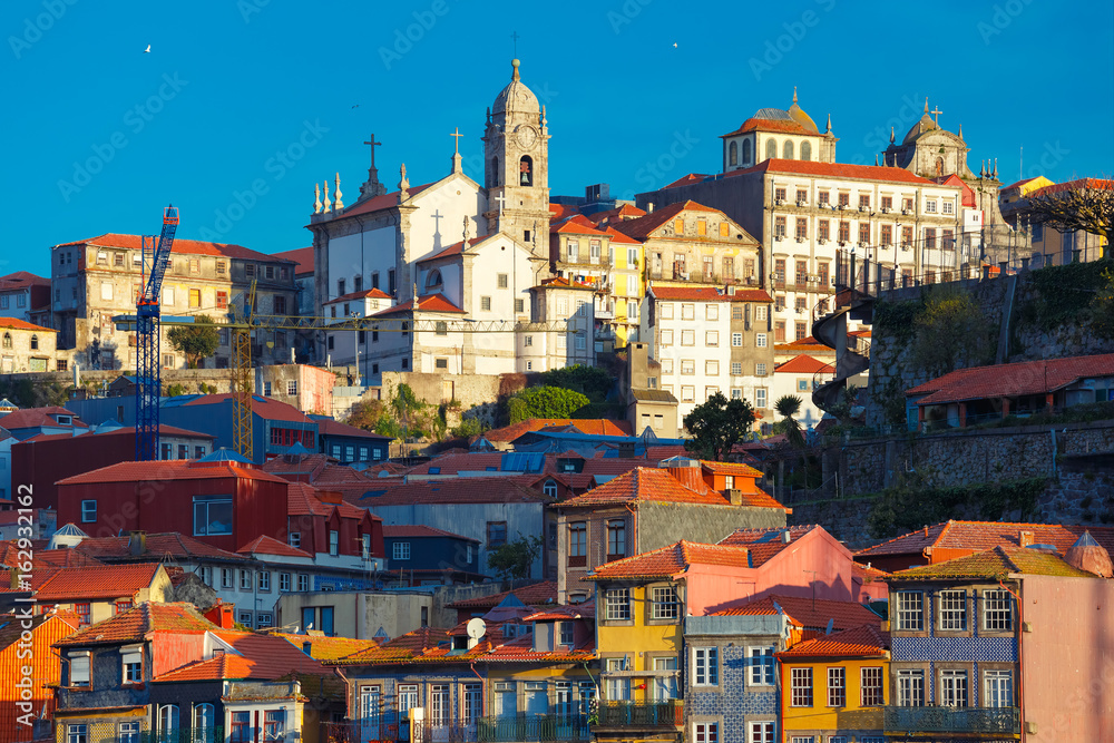 Aerial view with traditional multicolored quaint houses in Old town of Porto in the sunny morning, Portugal