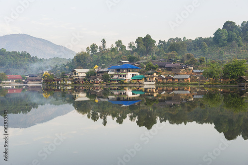 Tribal high hill village locate at the river bank with water reflection, sun rise warm tone, peace mind, fresh