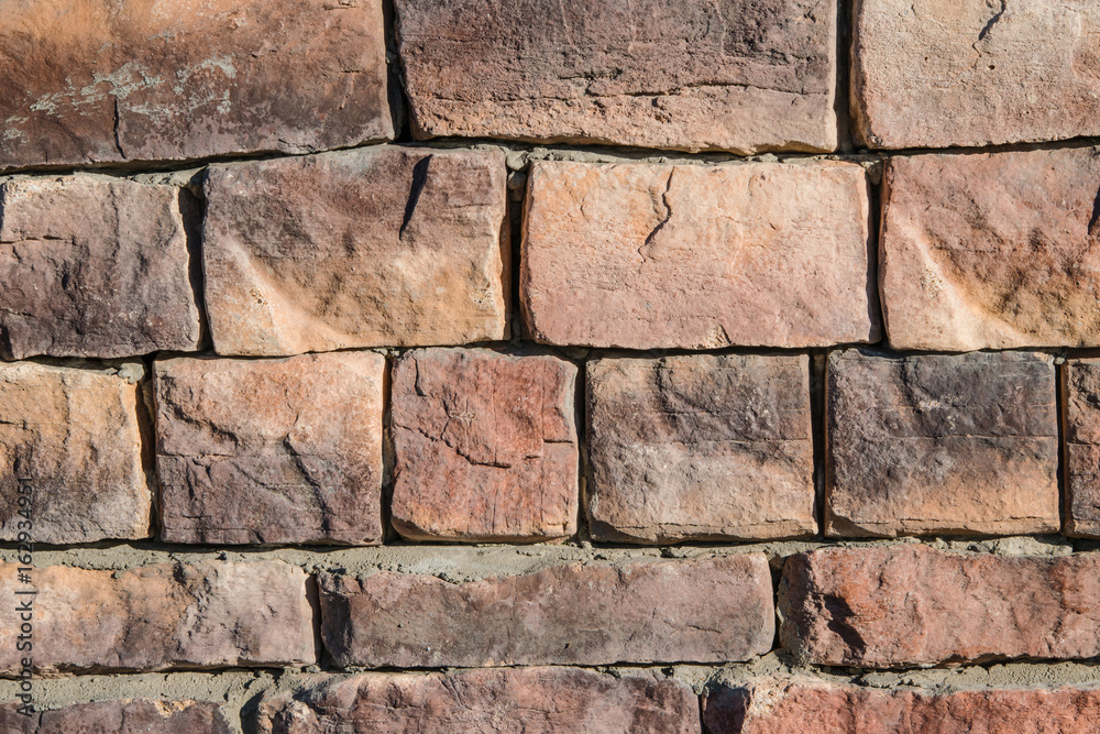 Abstract background texture of an old light brown stones in the wall Abstract background texture of an old light brown stones in the wall