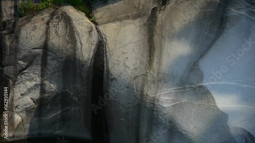 Mountain waterfall stream into pool from multilayer stone,stone texture mechanism. photo