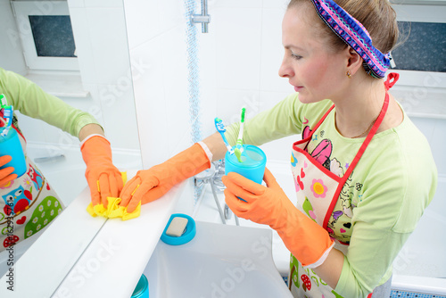Housemaid cleaning a bathroom, closeup shot