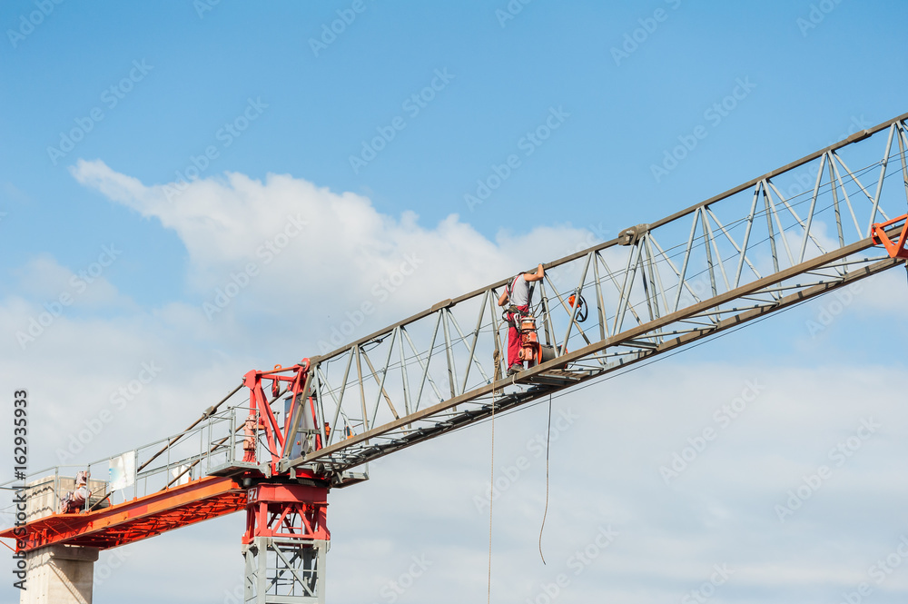 Electrician repairs an electric motor on a crane.