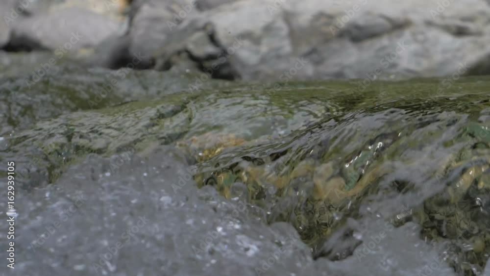 Water in a mountain river in slow motion video. Water in a mountain river in slow motion video.