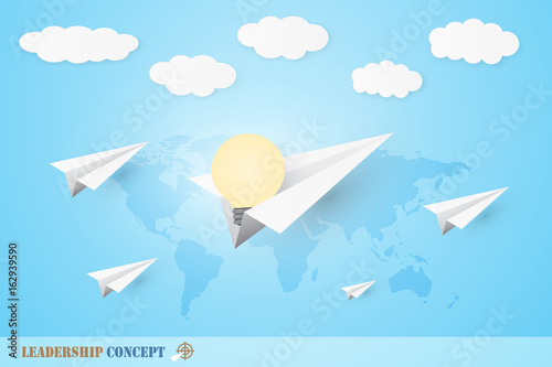 Leadership concept with white origami paper plane on world map background. Include light bulb and clouds.